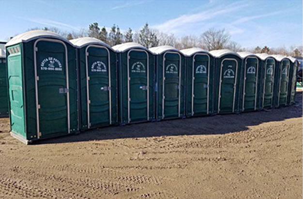 line of Gotta Go Potties green portable toilets for construction sites