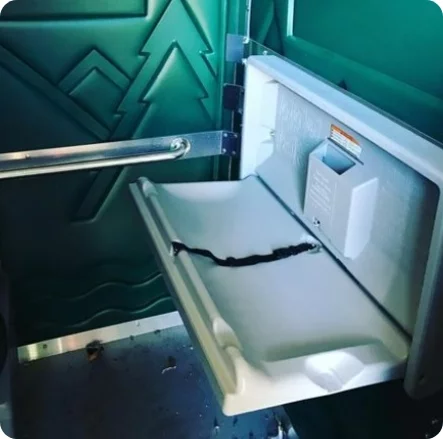 a photo of the inside of a portable potty with a diaper changing station