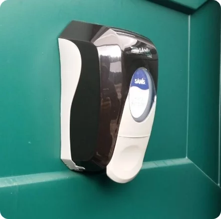 a hand sanitizer dispenser installed inside a porta potty