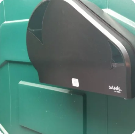 a toilet paper dispenser inside of a portta potty