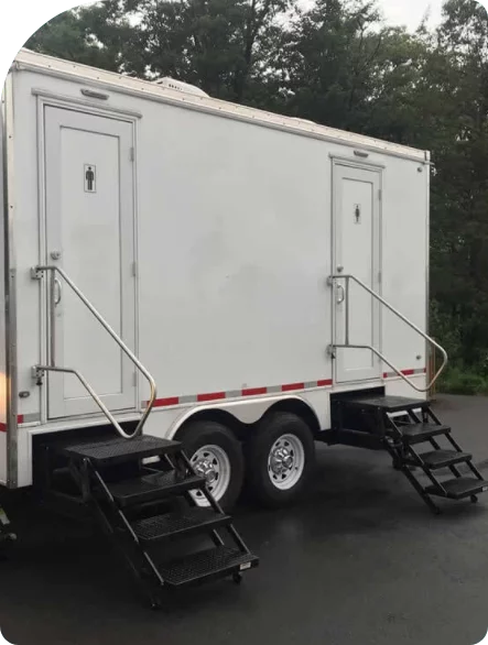 a white portable toilet trailer